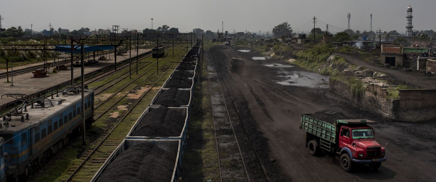 A truck loaded with coal drives past a freight train carrying coal at Chainpur village near Hazaribagh in India’s eastern state of Jharkhand.