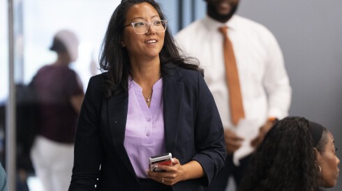 Holly Kim, who is running for state comptroller, walks to the stage to give her remarks during slating for Cook County Democrats at IBEW Local 134, July 18, 2025.