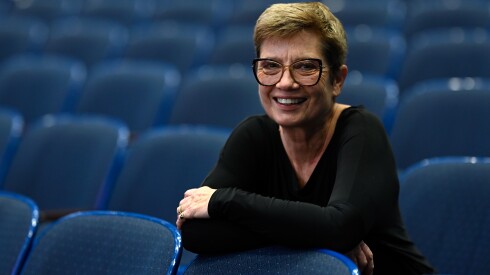Penelope Sachs, an Evanston Symphony Orchestra violist, sits for a portrait in the audience before the Evanston Symphony Orchestra's "A Very Special Concert" at Evanston Township High School on Sunday, Dec. 14, 2025.