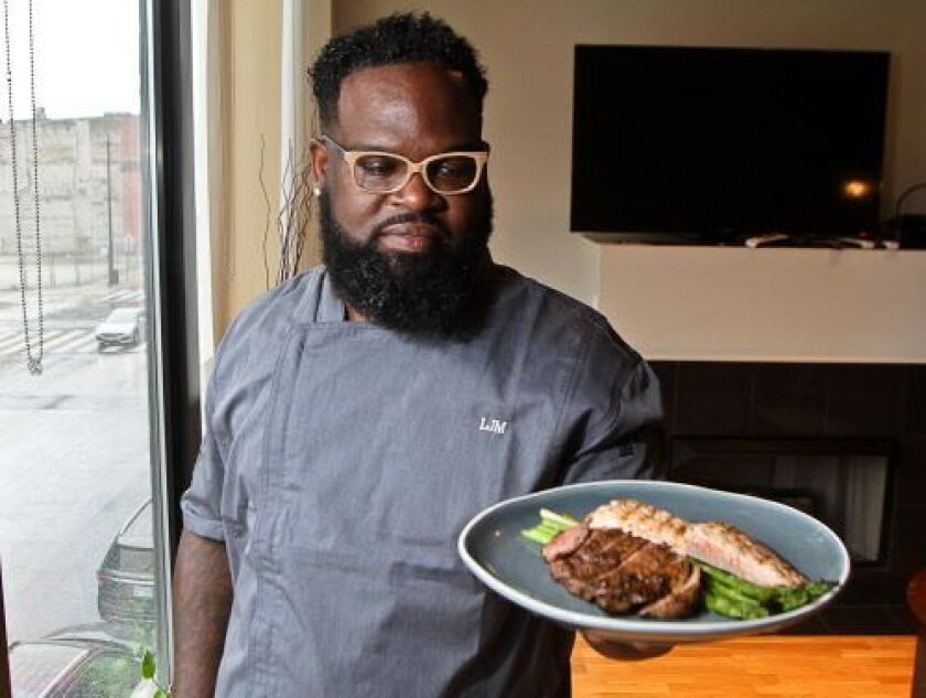 Chef Lamar Moore presents a healthy meal of grilled rib eye steak, salmon and asparagus. | Leslie Adkins/For the Sun-Times