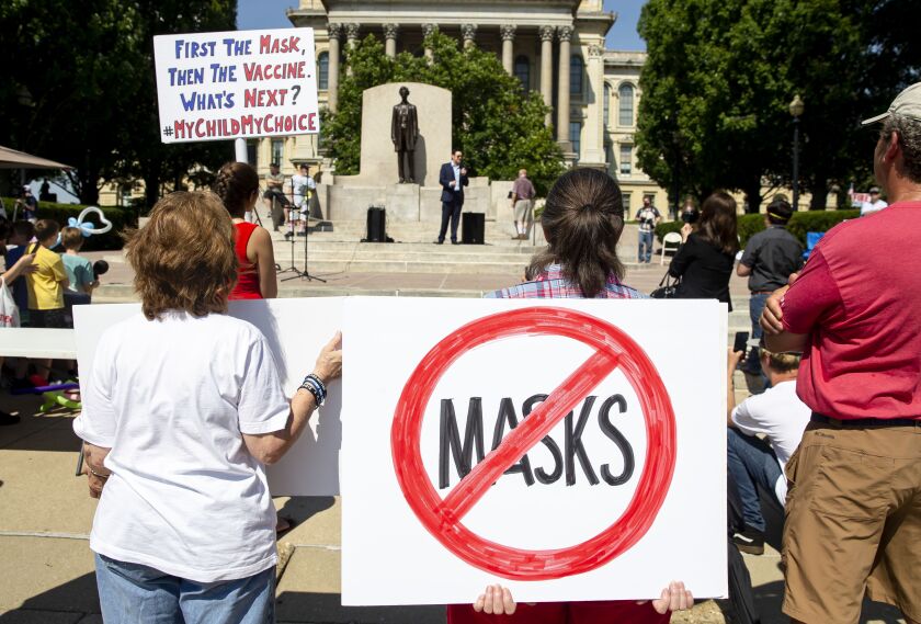 Protesters listen to William Kelly, host of the Citizen Kelly Show, as he speaks about suing Gov. JB Pritzker over COVID-19 restrictions on Saturday, July 25, 2020 in Springfield.