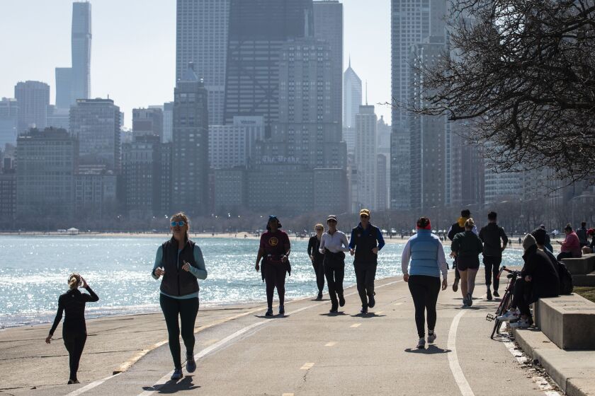 Hundreds could be seen enjoying warm weather on along Lake Michigan near Oak Street Beach, Wednesday
