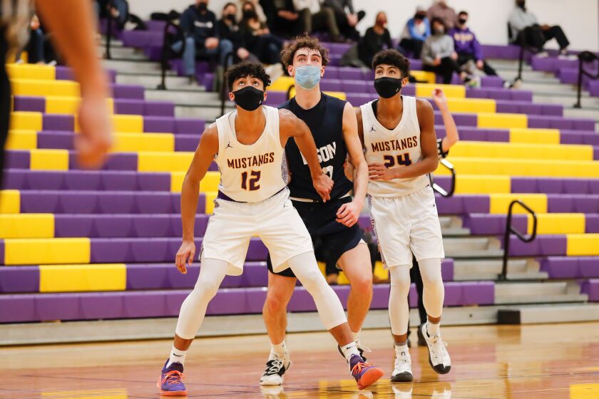 Rolling Meadows’ Max Christie (12) and Cameron Christie (24) cover Buffalo Groves’ Kam Craft (12).