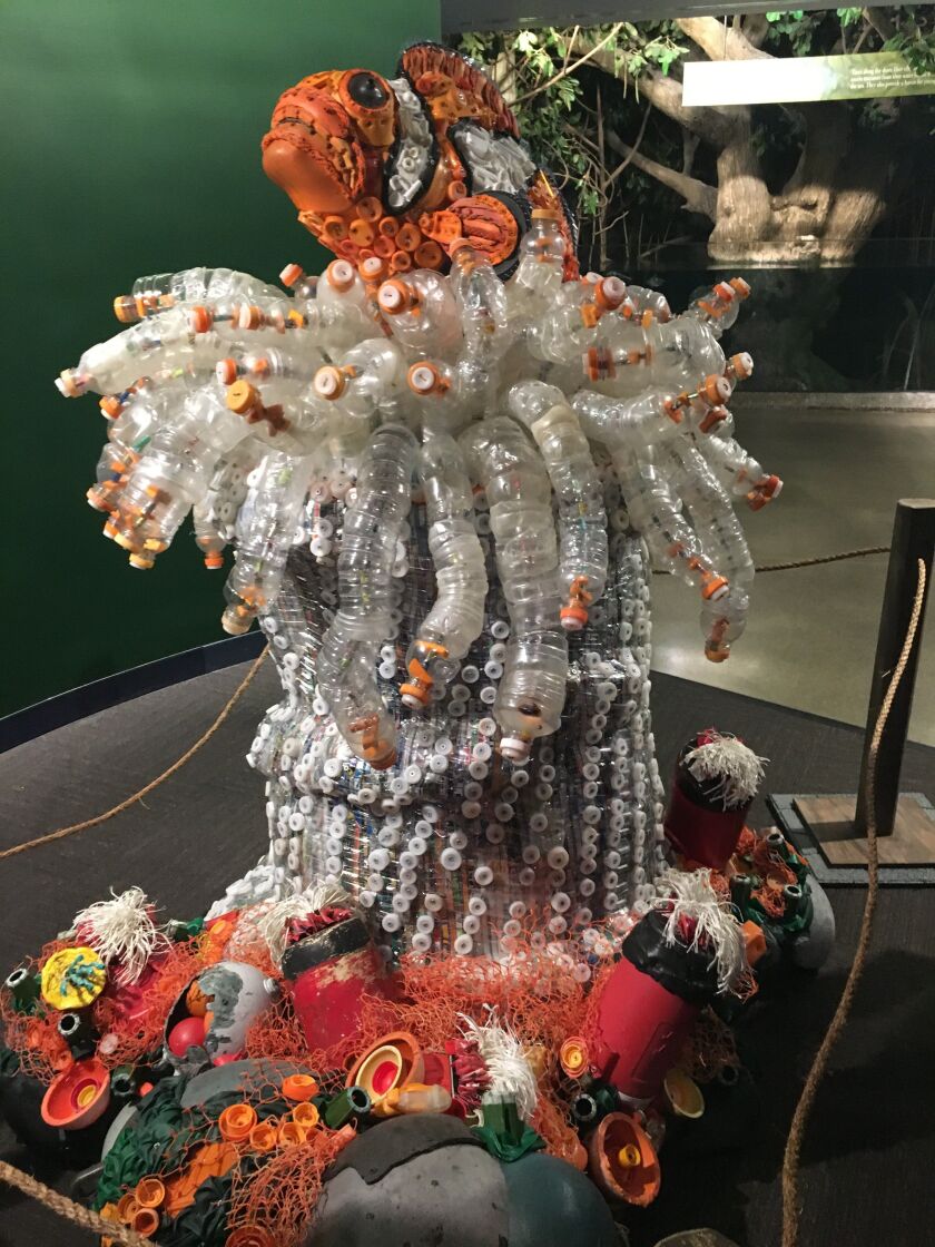 There are informational boards on the walls near the sculptures that encourage visitors to find key items in the art pieces. | Madeline Kenney/Sun-Times