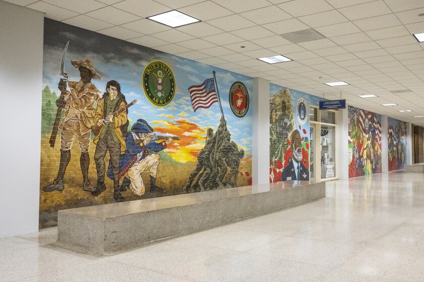 The mural encompasses four 25-foot panels in the hallway outside the Veterans Assistance Commission of Cook County office, starting with Army soldiers with muskets.