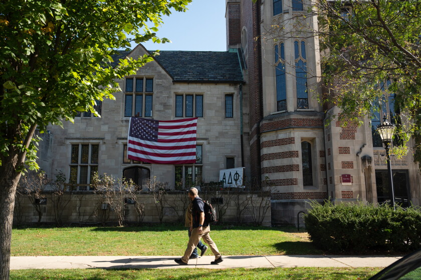 People walk past the Alpha Delta Phi house on Tuesday.