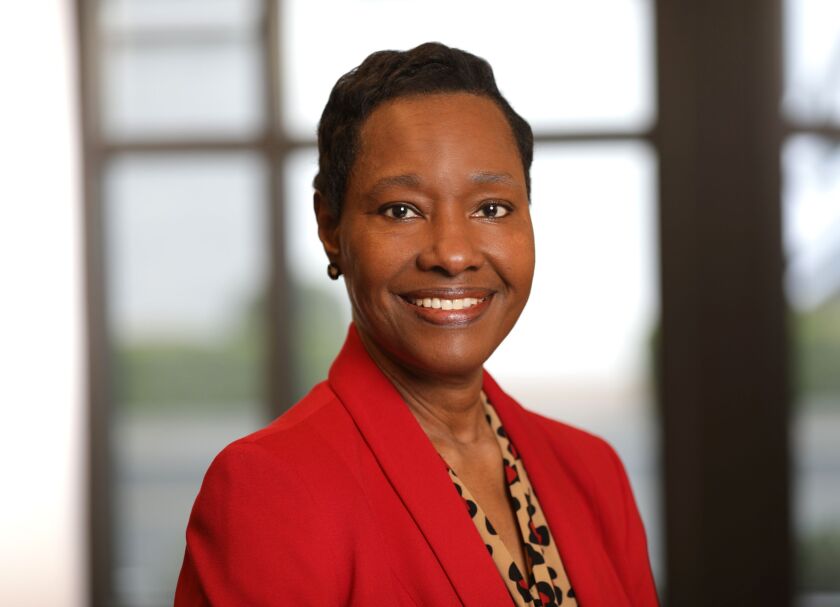 A smiling woman in a red jacket.