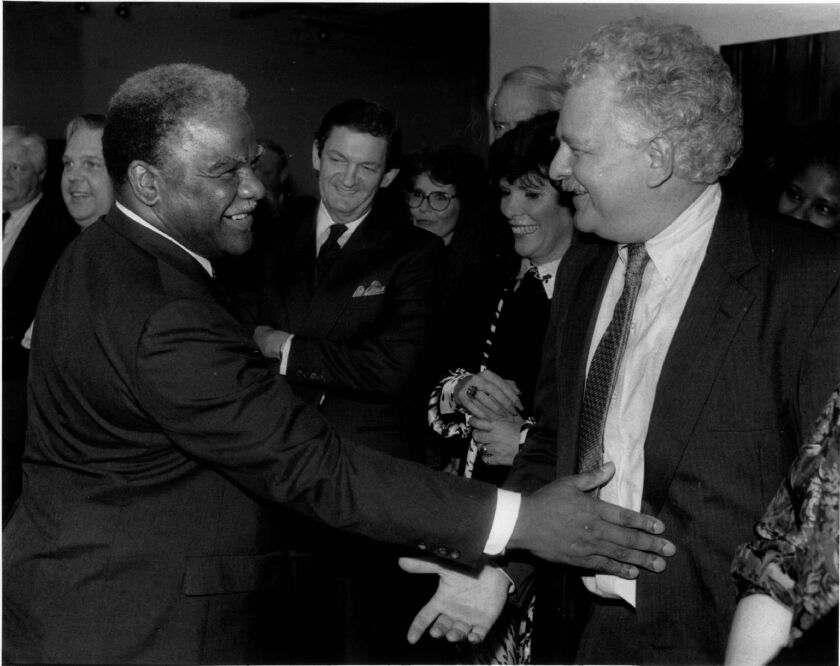 The late Chicago Mayor Harold Washington playfully pats then Chicago Sun-Times chief political columnist Basil Talbott Jr. at his farewell party at the Zolla-Lieberman Gallery.