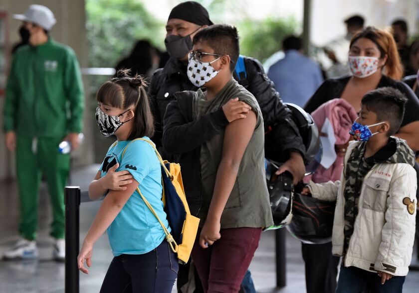 Minors leave after being inoculated with the first dose of the Pfizer-BioNtech vaccine at the Vasconcelos Library in Mexico City on Monday.