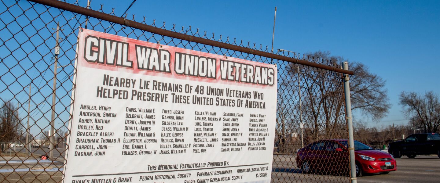 A sign lists the names of the 48 Civil War veterans believed to be buried under the pavement in the area around 3915 SW Adams in Peoria.