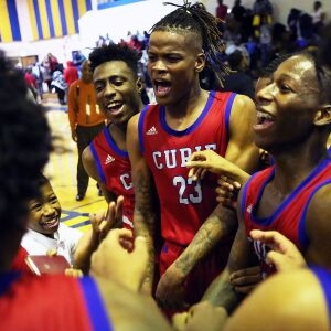 Curie’s Ramean Hinton (23) and the rest of the Condors celebrate after a come-from-behind victory over Simeon.
