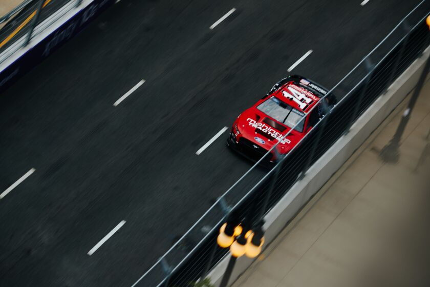 Cars race down Michigan Ave during NASCAR’s first street race in downtown, on Saturday, July 1, 2023.