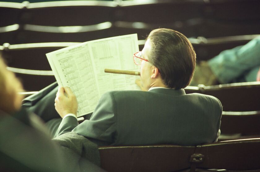 A horse player studies the program at Hawthorne Race Course in 1996.