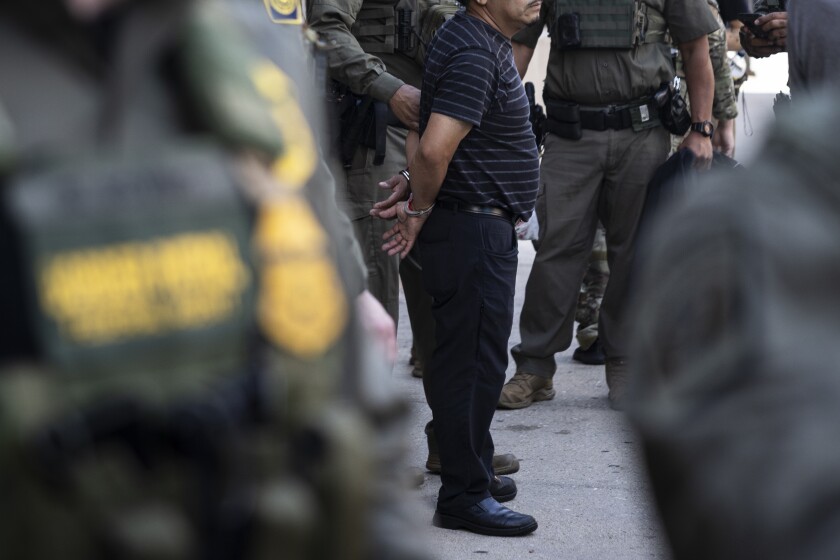 Federal immigration enforcement agents detain a man who took off as they were walking on North Clark Street near West Superior Street in River North, Sunday, Sept. 28, 2025. | Ashlee Rezin/Sun-Times
