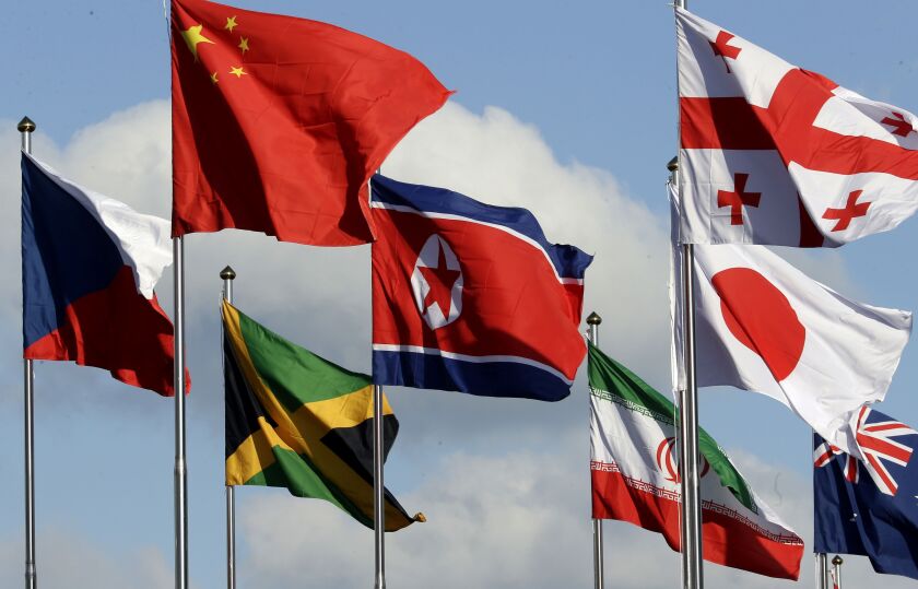 The North Korean flag, center, flies amongst flags from many nations as they fly at the Olympic Village at the 2018 Winter Olympics in Gangneung, South Korea, on Thursday. | AP photo