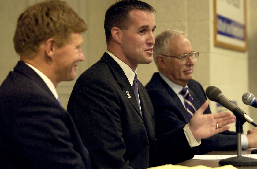 Pat Fitzgerald is named Northwestern's 29th head football coach at a news conference at the school on Friday afternoon, July 7, 2006. At left is Northwestern Director of Athletics Mark Murphy, and at right is Northwestern University President, Henry S. Bienen.