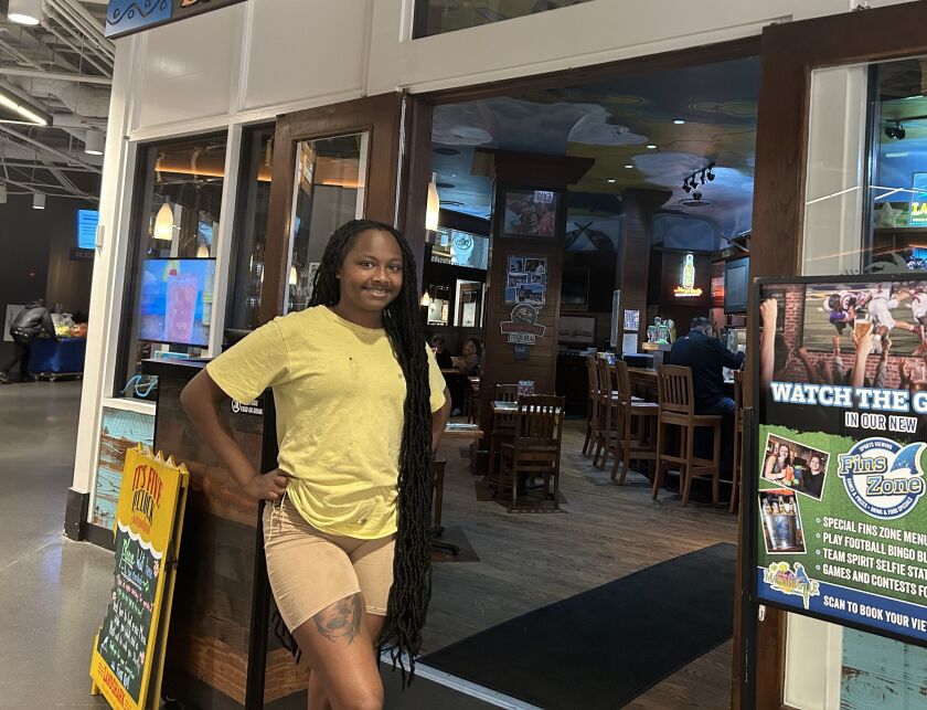 Cynshae Mitchell, a bartender at Margaritaville at Navy Pier, stands in front of the restaurant on Sept. 19, 2023.