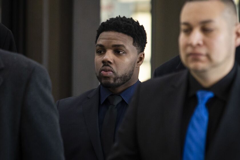 Flanked by attorneys and supporters, Amtrak police officer LaRoyce Tankson walks into the Leighton Criminal Courthouse, Friday morning, Sept. 28, 2020. Tankson was charged with first-degree murder for the fatal on-duty shooting of a Minnesota man outside Union Station in February 2017.