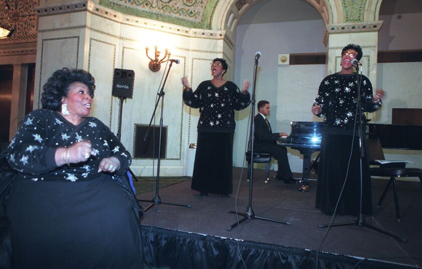 The Barrett Sisters — from left, Delois Barrett Campbell, Rodessa Barrett Porter and Billie Barrett Greenbey — with Chip Johnson on piano, performing Feb. 1, 1998, at the Chicago Cultural Center during the kickoff of an African-American History Month festiva “The Grand Ye Ye.”