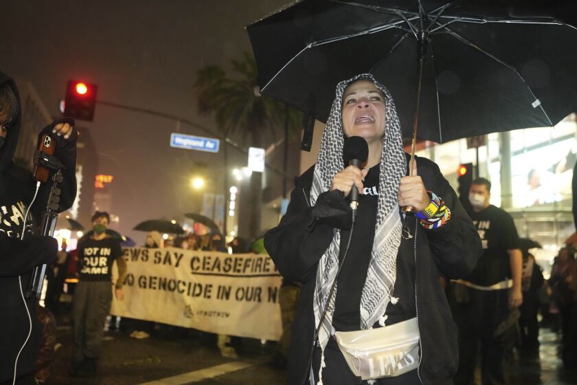 Melina Abdullah, co-founder of the Black Lives Matter chapter in Los Angeles, participates in a sit-in under the rain demanding a cease-fire in the Israel-Hamas war in Los Angeles on Wednesday,