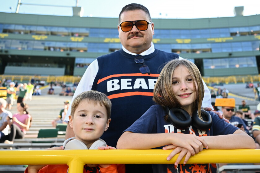 Chicago Bears fans pose before a game against the Green Bay Packers at Lambeau Field on Sunday.