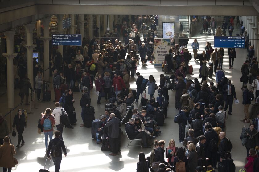 Travelers queue up at London’s St. Pancras rail station after services were suspended on the Brussels Eurostar train route because of the attacks in Belgium. | Matt Dunham/Associated Press