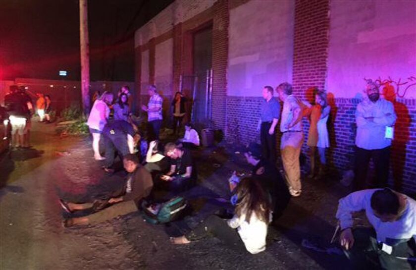 <small><strong>Passengers gather near the scene of an Amtrak train derailment Tuesday night in Philadelphia. Train 188 was traveling from Washington to New York City. | Paul Cheung/AP</strong></small>