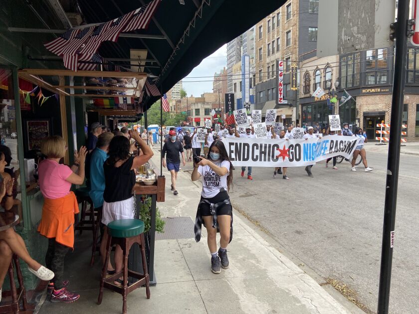 Customers at Butch McGuire’s on Division Street applauded marchers Saturday.