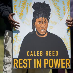 The family of Caleb Reed, an activist who was fatally shot in West Rogers Park Friday July 31, 2020, hold balloons and an illustration of Reed during a press conference outside Mather High School Tuesday afternoon August 4, 2020. The 17-year-old youth activist advocated for the removal of police in Chicago Public Schools.
