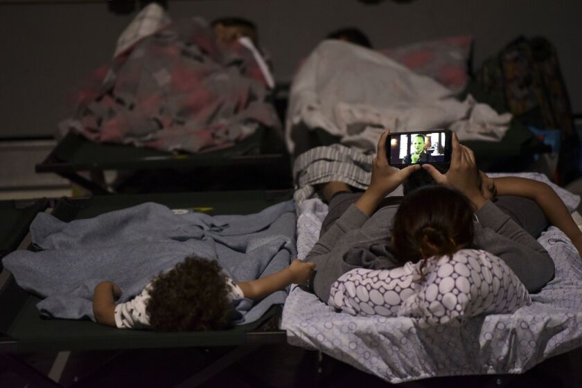 A woman and a child rest on cots at Humacao Arena refugee center, waiting for the imminent impact of Maria, a Category 5 hurricane. They were among about 137 people who arrived at the refuge from different parts of the eastern region of the Island. | Carl