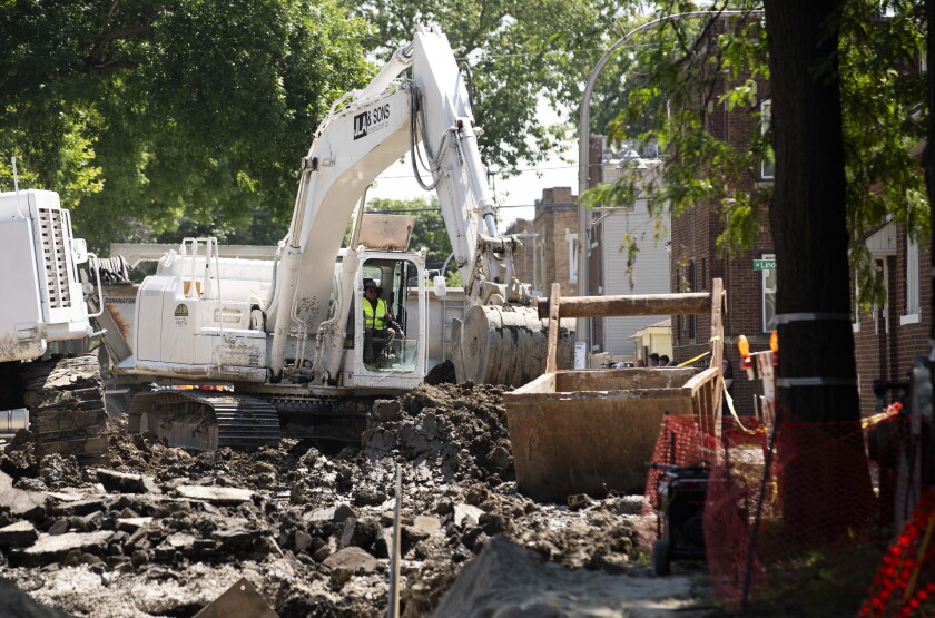 A worker operates an excavator in the 5500 block of W. LeMoyne Street in Austin