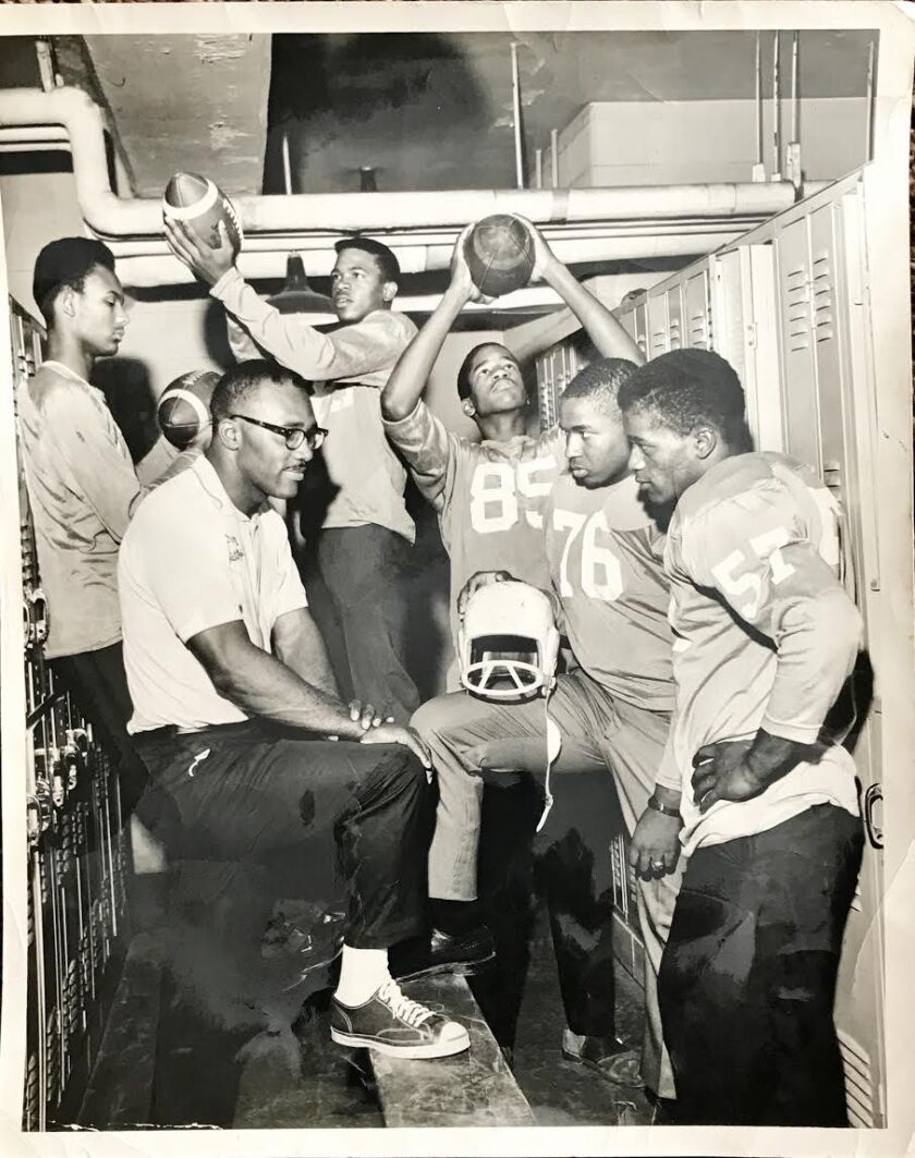 Coach Sherman Howard with players at Harlan High School circa the early 1970s.