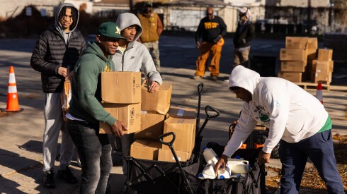 Site steward Marvin Yates carries boxes of nonperishables during an emergency food giveaway organized by Grow Greater Englewood and the Englewood Food Sovereignty Network in partnership with the Greater Chicago Food Depository Saturday in Englewood.
