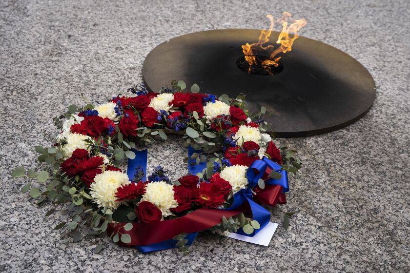 A wreath-laying was part of a ceremony on Monday, April 12, 2021 at Daley Plaza to honor essential workers and the Brown and Black communities hit hard by the COVID-19 pandemic.