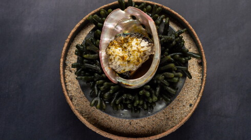 The Monterey Bay abalone dish, served at Smyth. The dish includes maitake mushrooms and is served with a tableside sauce made from abalone stock, mushrooms, brown butter, sea lettuce and ogo.