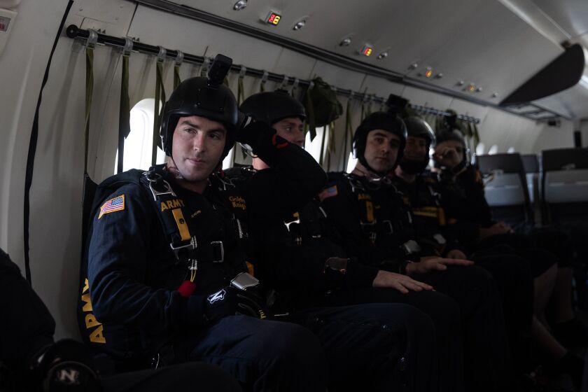 U.S. Army Golden Knights parachute team Specialist Brandon Hexum (left) waits to take off for a practice jump Friday in preparation for the 2023 Chicago Air and Water Show.