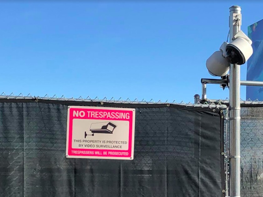 <em>A covered fence with surveillance cameras surround the site where 58 were killed at a concert in 2017.</em>