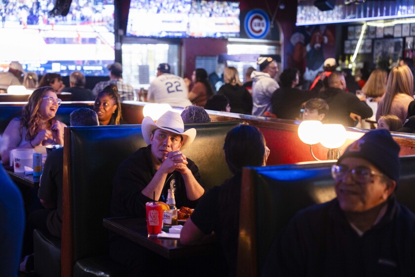 People watch the game between the University of Illinois and the University of Connecticut’s basketball teams at Mullen’s Sports Bar and Grill.