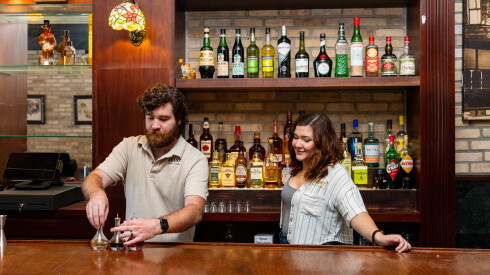 Owners Marty O'Connor and Mary Nedbalski stand behind the bar at Gunny's Pub in Lincoln Park.