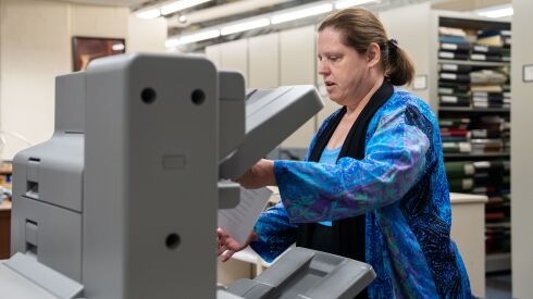 CSO librarian Carole Keller prints out orchestral parts of a score that has been sent electronically for use by the symphony. The machine also staples and folds the parts for each musician.