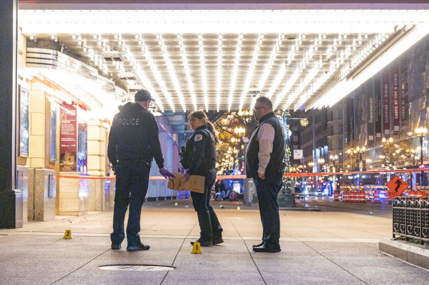 Chicago police investigate the scene where multiple people were shot outside the Chicago Theatre in the Loop, Friday, Nov. 21, 2025.