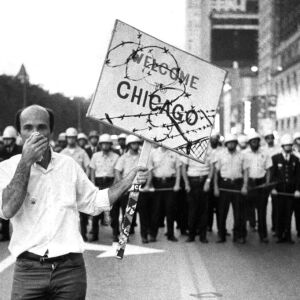 A demonstrator fights off tear gas as he walks in front of a police barricade at the Conrad Hilton Hotel during the 1968 Democratic National Convention in Chicago. | Sun-Times files