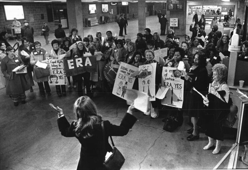 Alana Smart leads a group of Equal Rights Amendment supporters in a song before the group left Union Station for Springfield in April of 1975. Sun-Times File Photo/Charles Krejcsl.