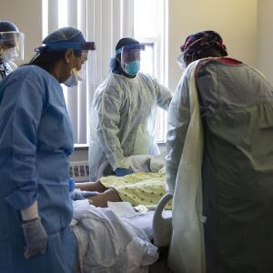 Doctors and nurses tend to a 56-year-old woman suffering from COVID-19 who prompted a rapid response, meaning respiratory or cardiac arrest, at Roseland Community Hospital on the Far South Side, Tuesday afternoon, April 28, 2020.