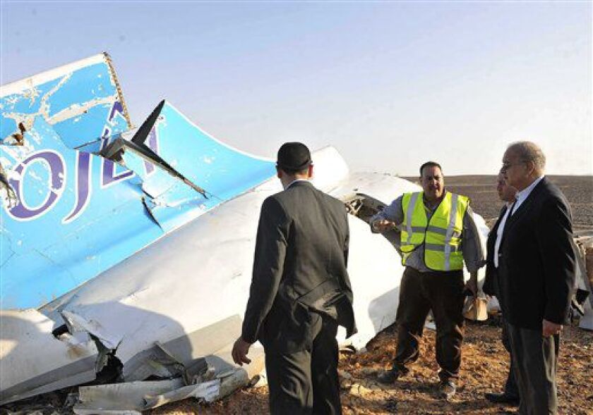 Sherif Ismail (right) looks at the remains of a crashed passenger jet in Hassana, Egypt, on Saturday, Oct. 31, 2015. | Suliman el-Oteify/Egyptian Prime Minister’s Office via AP