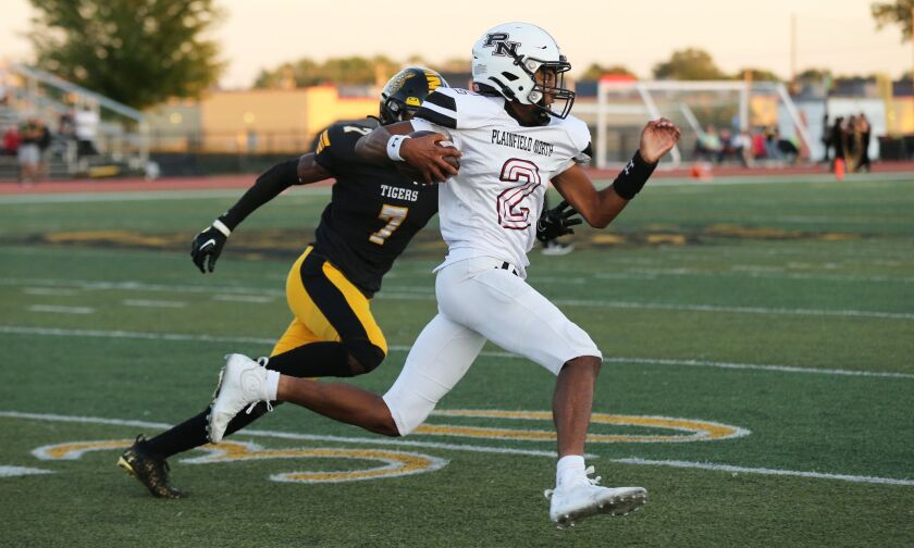 Plainfield North’s Demir Ashiru (2) gets to the edge just out of reach of Joliet West’s Derion McBroom (7).