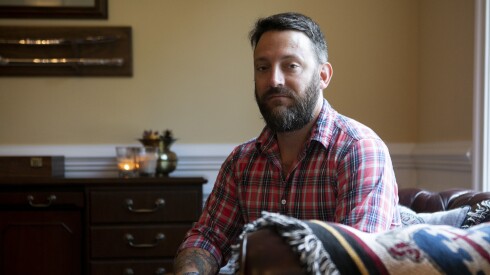 James Rudisill, FBI agent and retired Army captain, sits on a couch at his home in Virginia.