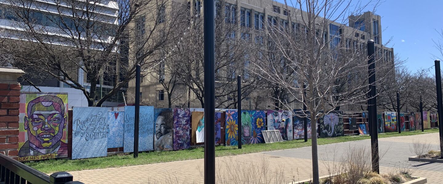 A stretch of murals at the DuSable Black History Museum and Education Center that inludes a painting, at the far left, of Ahmaud Arbery, a Black man killed by white men while jogging in Georgia in 2020. The mural, by the artist who goes by Nick Apple, originally was painted on the front of a Logan Square restaurant.