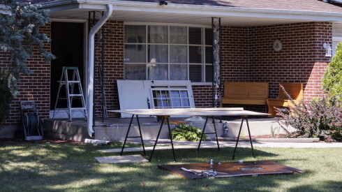 A broken door sits on a lawn at 904 Chippewa Drive in Elgin where repairs already had started following a federal raid Tuesday.