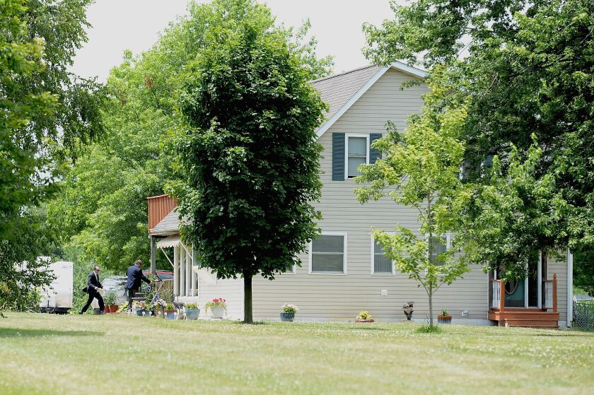 Law enforcement personnel enter the home of James T. Hodgkinson near Belleville on Wednesday. | Michael B. Thomas/Getty Images